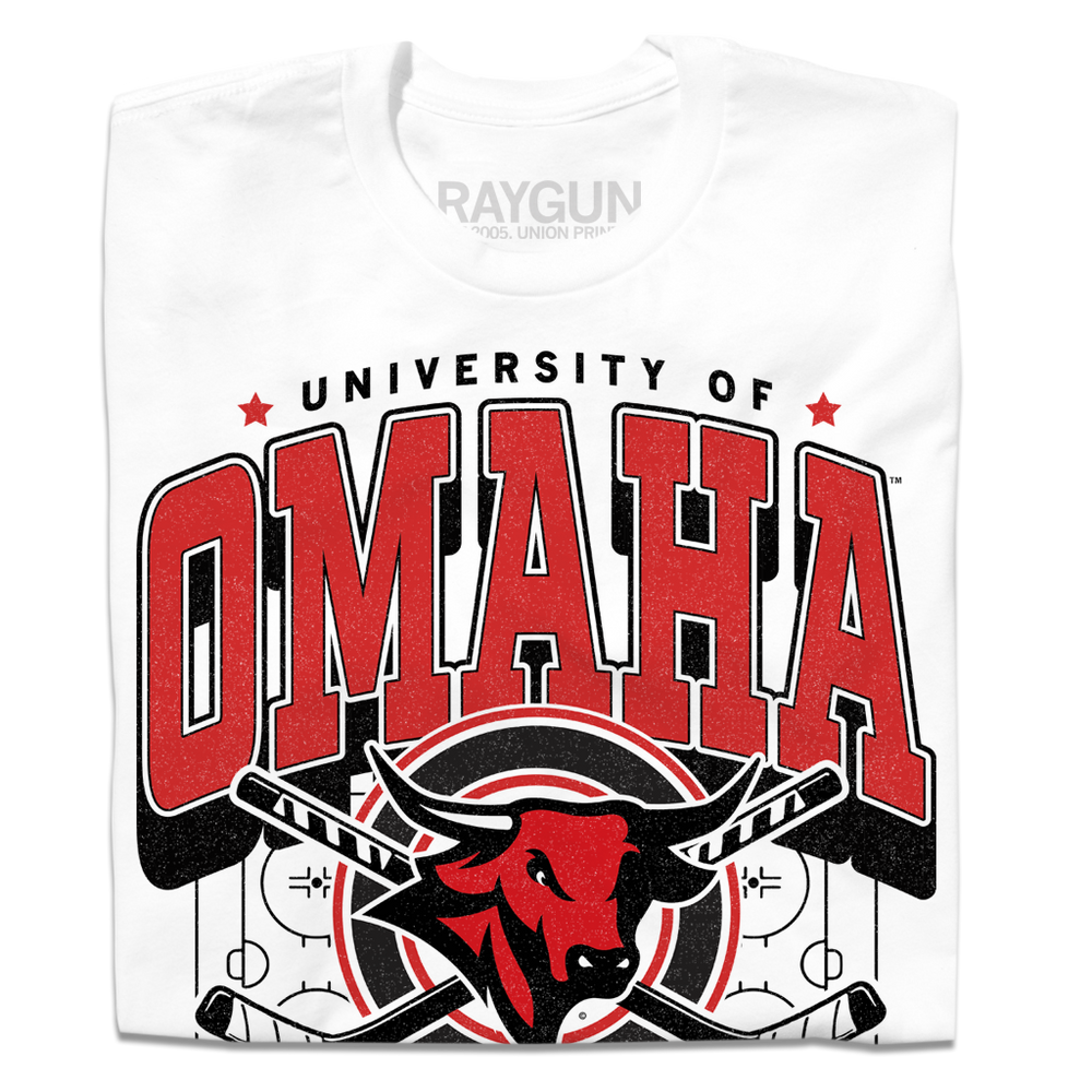 White shirt with red and black ink that says, "University of Omaha Hockey. Home of the Mavericks" with the university's bull mascot logo over a pair of crossing hockey sticks and an ice rink.