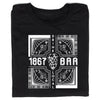A black, union-made T-shirt featuring a white graphic with the text 1867, BAR, and DRINK LOCAL surrounding a central hop illustration and four corner panels each showing a skull pierced by a dagger.