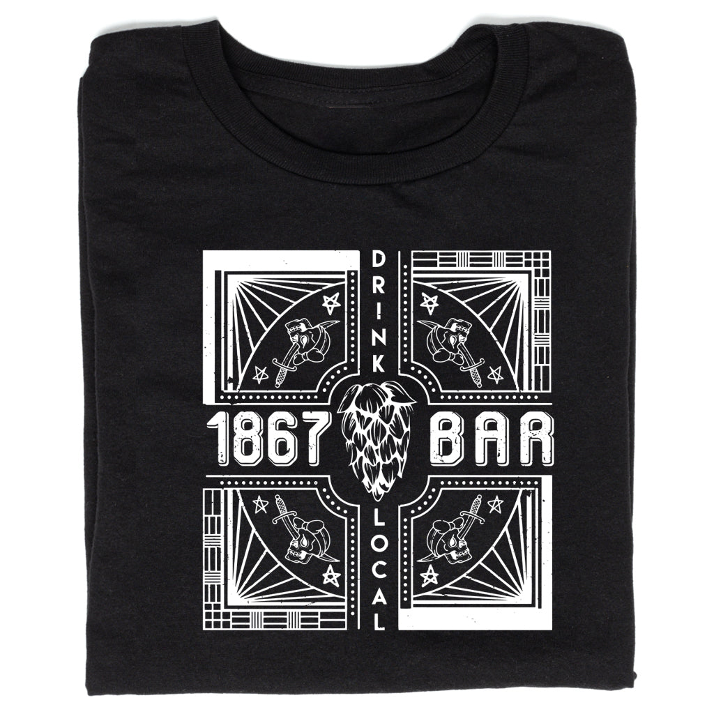 A black, union-made T-shirt featuring a white graphic with the text 1867, BAR, and DRINK LOCAL surrounding a central hop illustration and four corner panels each showing a skull pierced by a dagger.