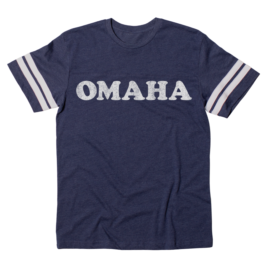 Navy blue short-sleeve vintage Omaha jersey with white stripes on the sleeves and the word OMAHA printed in distressed white letters across the chest.