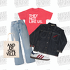 A red t-shirt printed with THEY NOT LIKE US, blue jeans, a vintage Kanijeans jacket, a white canvas tote bag labeled ANDERSONVILLE, and a white and red Adidas sneaker arranged on a branded background.