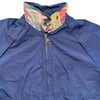 Navy blue Members Only zip-up jacket with an ethically sourced plaid collar and a small embroidered emblem on the chest.