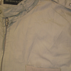 Large tan Members Only jacket featuring a zip-up front and a high collar.
