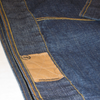 Dark blue vintage Rocawear denim jacket with yellow topstitching and a tan leather patch.