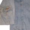 Light blue light wash denim jacket sleeve cuff featuring a single metal snap button with red thread detail.