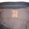A vintage sportswear denim jacket label featuring a line-art station wagon icon and the text Wooryz Sportswear, Made in Italy.