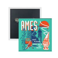 A teal square button in a retro 90's style with a navy print image the campanile in Ames. White & orange text in the top left says, "AMES" and smaller what text to the bottom right reads "quite playin' Ames with my heart." Accents include an orange gnome, orange bird, navy corn, white squiggles, and more.