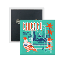 A teal square metal button in a retro 90's style with a navy print image of the the Cloud Gate statue in Chicago. Orange & white text at the top says, "Chicago" with white & blue text to the left that reads "Where Have You Bean All My Life?" There's also an orange & white pigeon, a white map of the L Train, orange Chicago flag stars, and other accents.