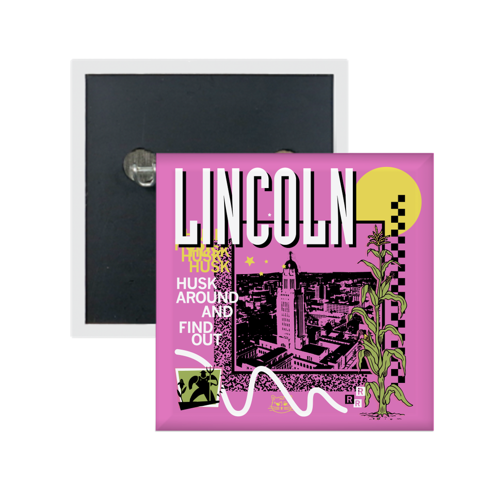 A pink square metal button in a retro 90's style with a black print image of the Nebraska Capitol in Lincoln. White text  across the tops says, "Lincoln" with more text to the left that reads, "Husk Around And Find Out." There's also a yellow sun in a corner, white squiggles, green corn, and other colorful accents.