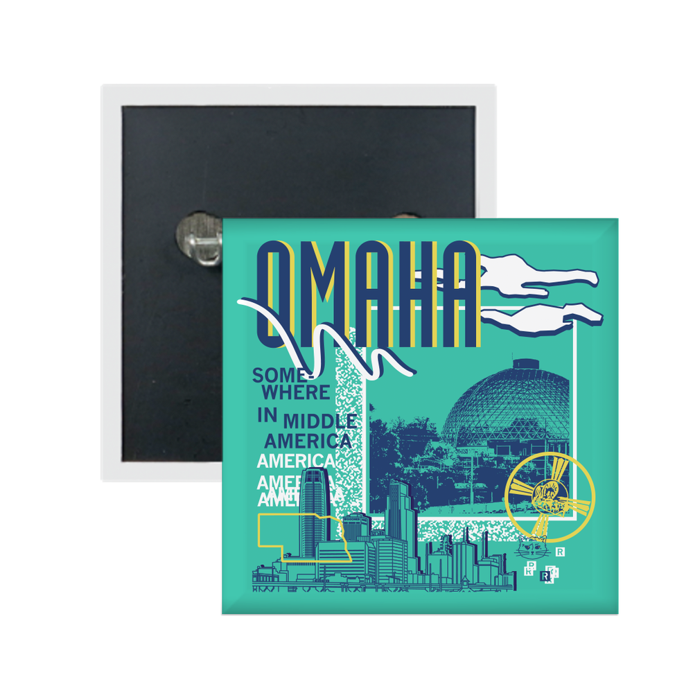 A teal square metal button in a retro 90's style with a navy print image of the Omaha Zoo dome to the right and Omaha skyline at the bottom. Navy text  across the tops says, "Omaha" with more text to the left that says, "Somewhere In Middle America." There's also a yellow outline of Nebraska, white clouds, a small navy cat face, and other colorful accents.