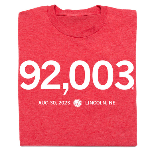 Union-made red RAYGUN t-shirt featuring the number 92,003 in large white text above the date AUG 30, 2023, a volleyball icon, and the text LINCOLN, NE.