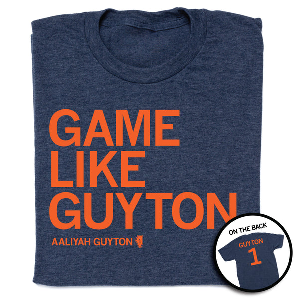 A folded heather navy t-shirt with orange ink that says, 