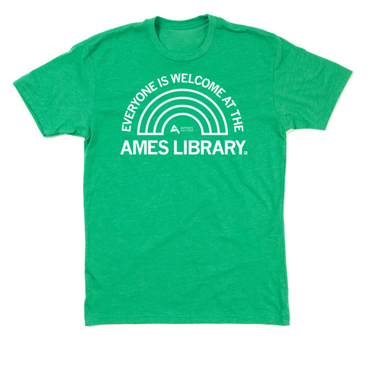 Green union-made t-shirt featuring a white graphic of a rainbow and the text EVERYONE IS WELCOME AT THE AMES LIBRARY.