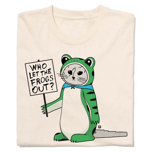 Folded natural colored t-shirt with RAYGUN's cat mascot, Gary, dressed in a frog costume while holding a sign that says, 