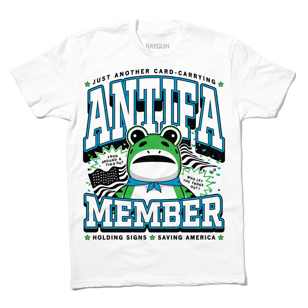 White t-shirt with the blue, black and green text that reads "Just another card-carrying ANTIFA member" above and below an illustration of the Portland protestor in a frog suit. To the sides are an American flag and the text "Frog around & find out. Who let the frogs out?"