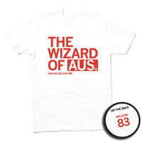 Short-sleeve white t-shirt with left-aligned red text that says, "THE WIZARD OF AUS" with "ARCHIE WILSON" in smaller text below. To the right of his name is an outline of Nebraska with the number "83" in its center. A circular picture to the bottom right shows the back of the shirt. The back is printed like a jersey with "WILSON" above a large 83.
