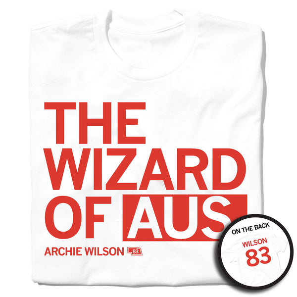 A folded white t-shirt with left-aligned red text that says, 