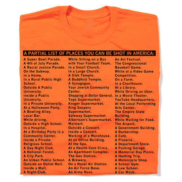 Bright orange RAYGUN t-shirt printed with black text titled A PARTIAL LIST OF PLACES YOU CAN BE SHOT IN AMERICA, followed by a list of locations ranging from schools and grocery stores to parks and religious centers.