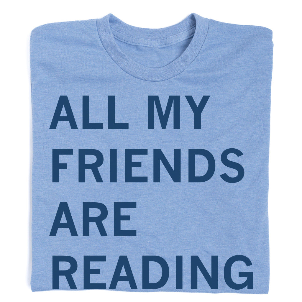 Light blue RAYGUN t-shirt with the text ALL MY FRIENDS ARE READING printed in navy blue.