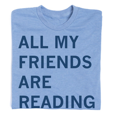 Light blue RAYGUN t-shirt with the text ALL MY FRIENDS ARE READING printed in navy blue.