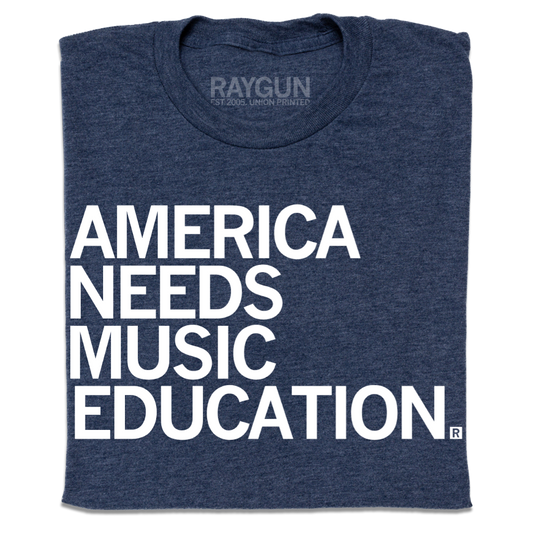 Heather denim blue t-shirt featuring the text AMERICA NEEDS MUSIC EDUCATION in large white capital letters.