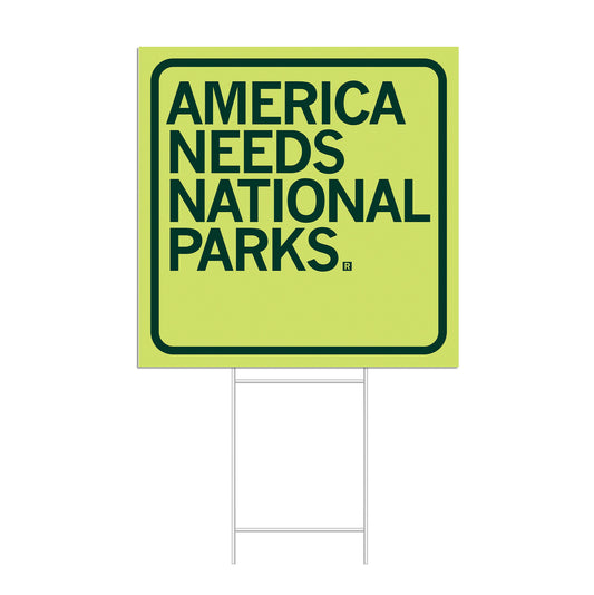 Square yard sign with a light green background and dark green text that reads, AMERICA NEEDS NATIONAL PARKS. This Made in USA yard sign features simple, bold lettering.