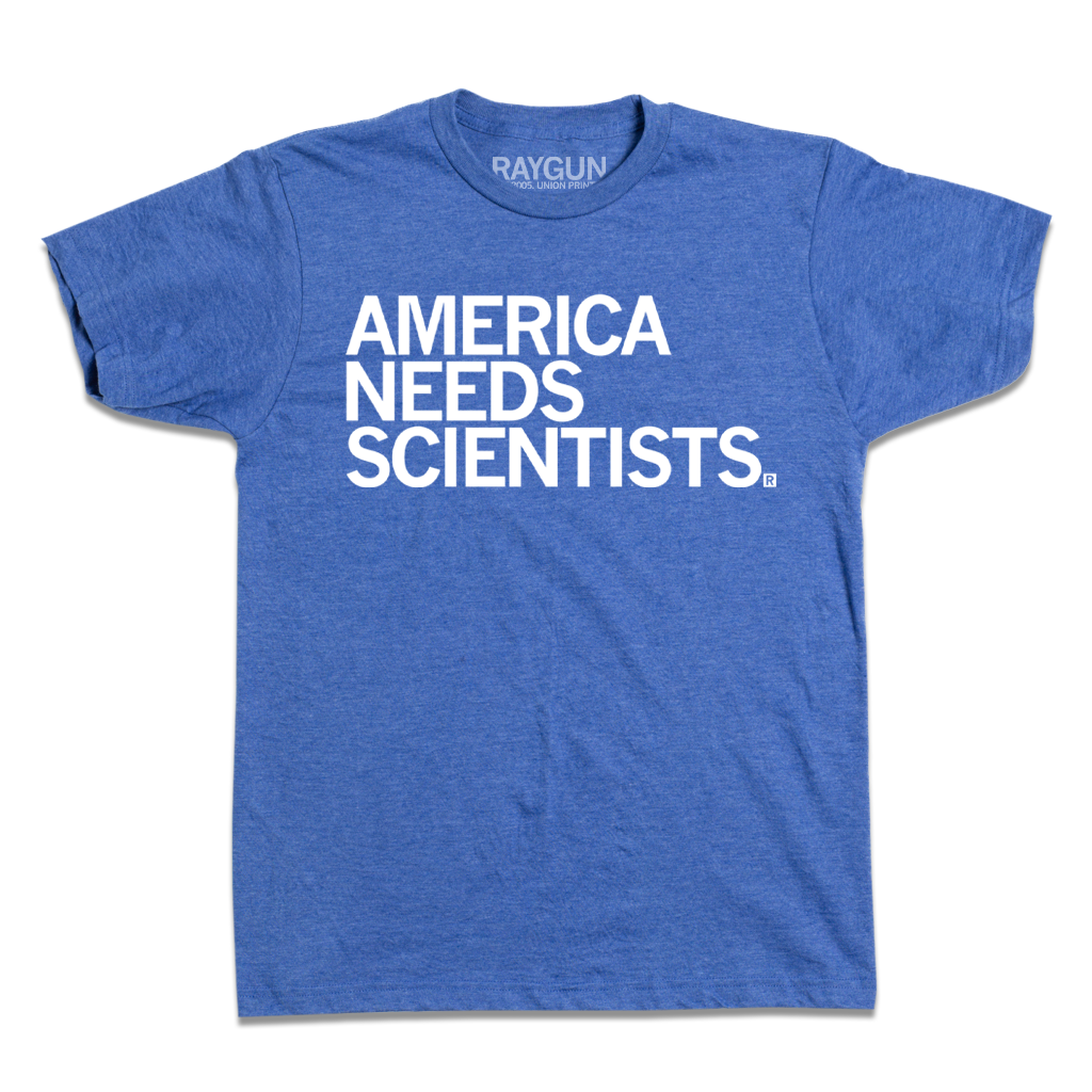 Blue t-shirt featuring the white text America Needs Scientists, printed in the USA by union labor.