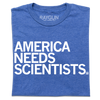 Blue t-shirt printed in the USA with the text AMERICA NEEDS SCIENTISTS in white capital letters.