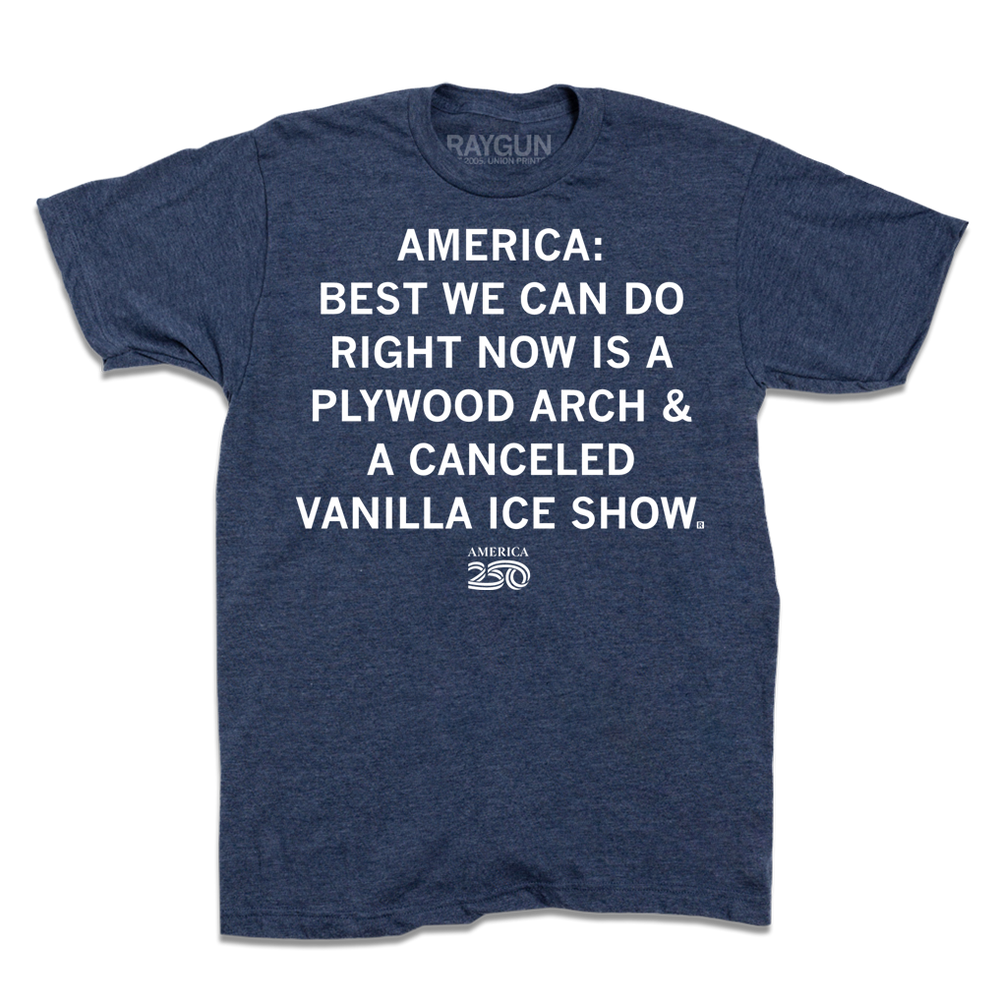 Short sleeve heather denim t-shirt with white ink text that says, "America 250: best we can do right now is a plywood arch &amp; a canceled Vanilla Ice show."