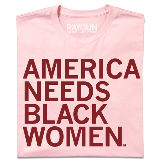 Light pink union-made t-shirt with the text AMERICA NEEDS BLACK WOMEN printed in dark red capital letters.