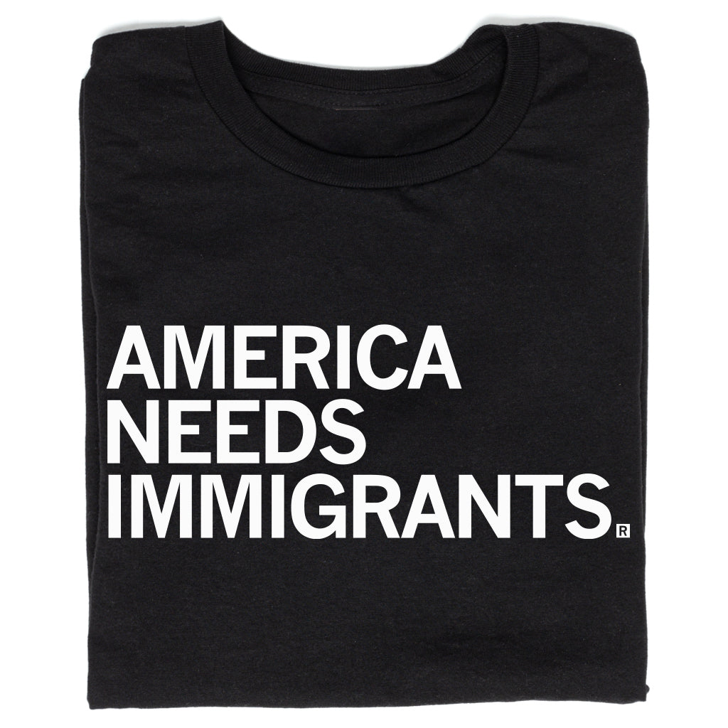 Black union labor t-shirt with the text AMERICA NEEDS IMMIGRANTS printed in white capital letters.