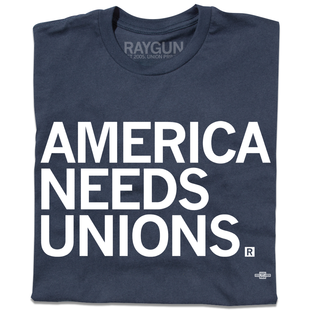 A folded navy t-shirt with "AMERICA NEEDS UNIONS" printed in white ink with our own union's union bug in the bottom right.