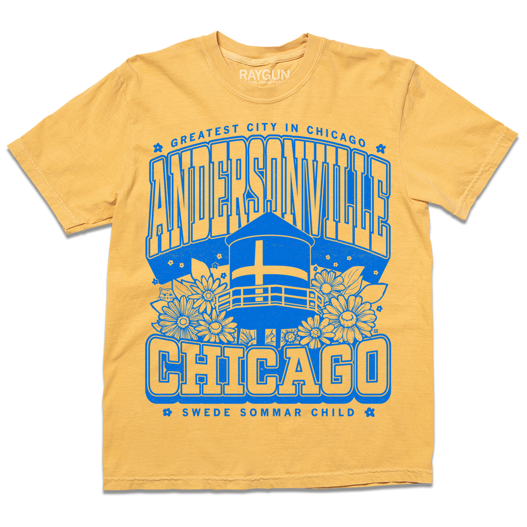 Heather gold t-shirt with bright blue print. Text from top-to-bottom reads "GREATEST CITY IN CHICAGO. ANDERSONVILLE. CHICAGO. SWEDE SOMMAR CHILD." There's an illustration of the Andersonville Swedish flag water tower in the center, surrounded by flowers.