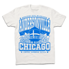 White t-shirt with bright blue print. Text from top-to-bottom reads "GREATEST CITY IN CHICAGO. ANDERSONVILLE. CHICAGO. SWEDE SOMMAR CHILD." There's an illustration of the Andersonville Swedish flag water tower in the center, surrounded by flowers.