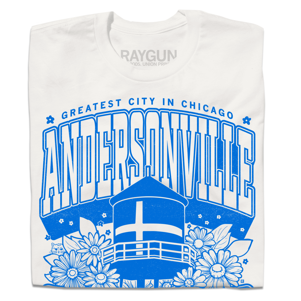 Folded short-sleeve white t-shirt with bright blue print. Text from top-to-bottom reads "GREATEST CITY IN CHICAGO. ANDERSONVILLE. CHICAGO. SWEDE SOMMAR CHILD." There's an illustration of the Andersonville Swedish flag water tower in the center, surrounded by flowers.