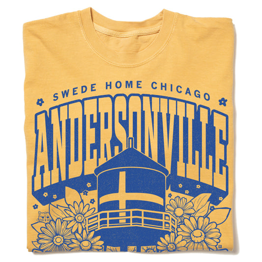 Mustard yellow RAYGUN t-shirt featuring a blue graphic with Swede Home Chicago and Andersonville text above an illustration of a water tower and flowers.