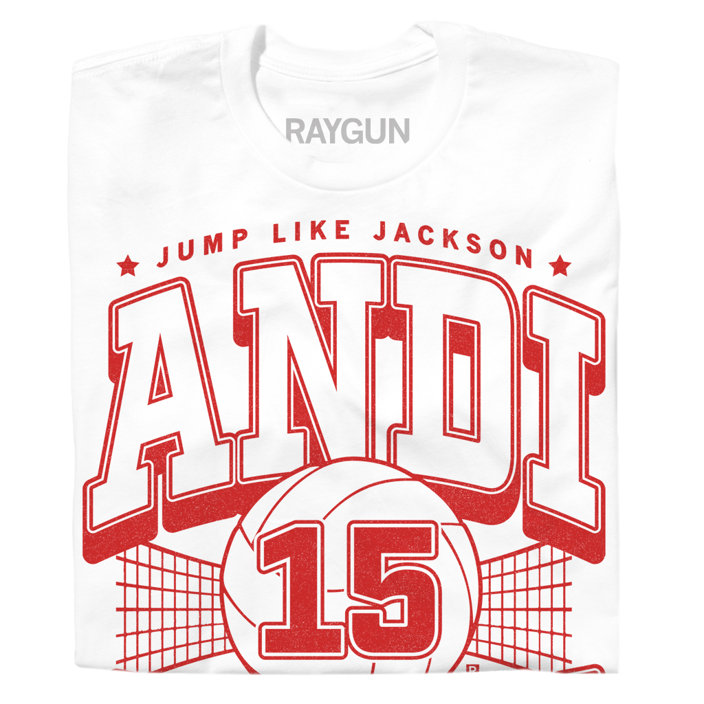 White Andi Jackson T-shirt with a red graphic featuring a volleyball, a net, the number 15, the text JUMP LIKE JACKSON, and the name ANDI in large varsity-style letters.