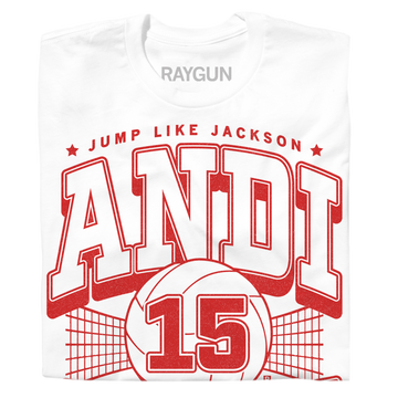 White Andi Jackson T-shirt with a red graphic featuring a volleyball, a net, the number 15, the text JUMP LIKE JACKSON, and the name ANDI in large varsity-style letters.