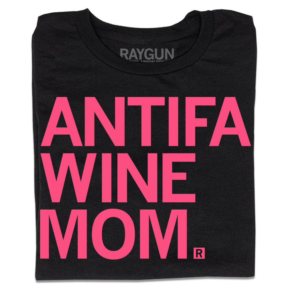 A folded black t-shirt with bright pink left aligned text that reads "ANTIFA Wine Mom"