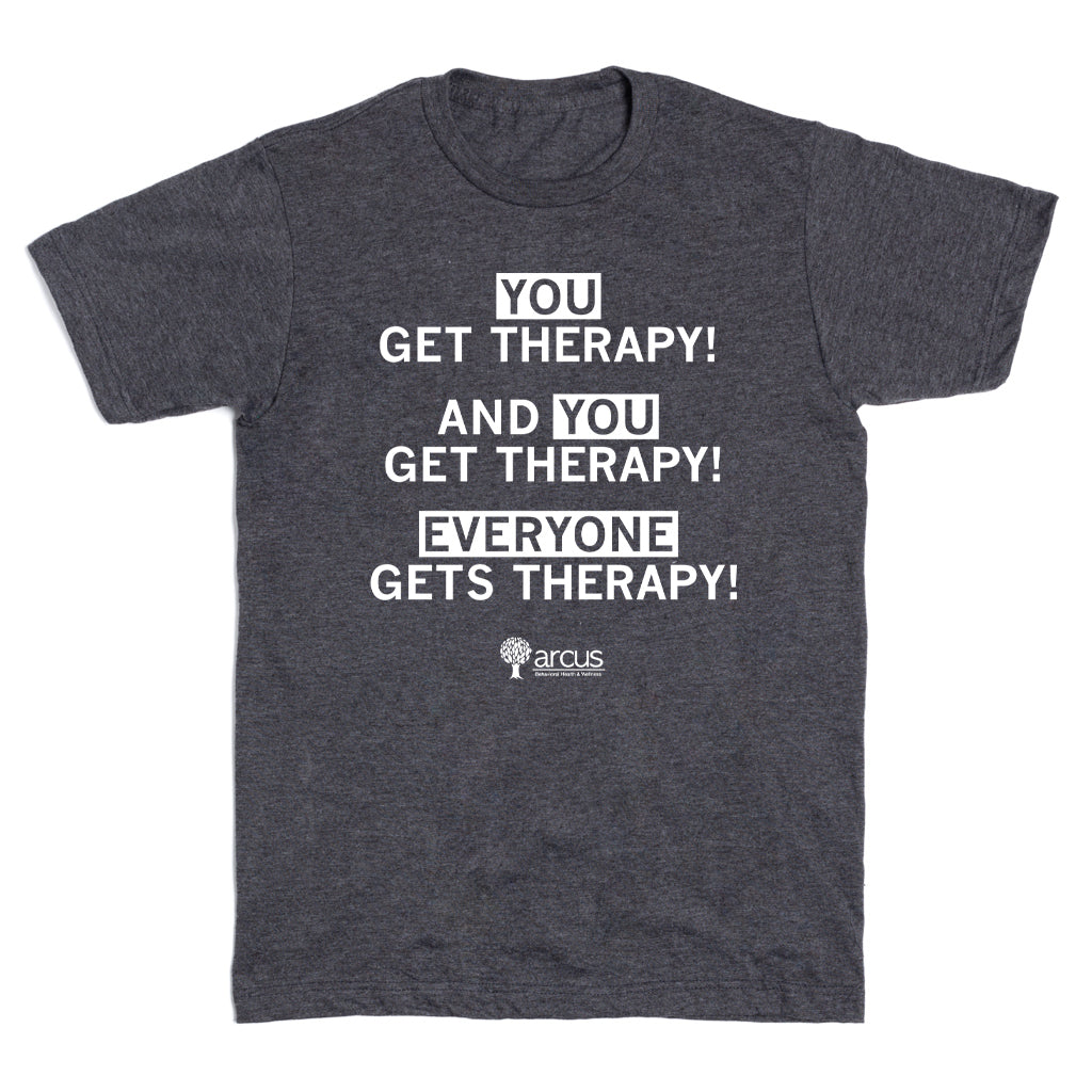 A grey RAYGUN t-shirt featuring the white text YOU GET THERAPY! AND YOU GET THERAPY! EVERYONE GETS THERAPY! with the Arcus Behavioral Health logo at the bottom.