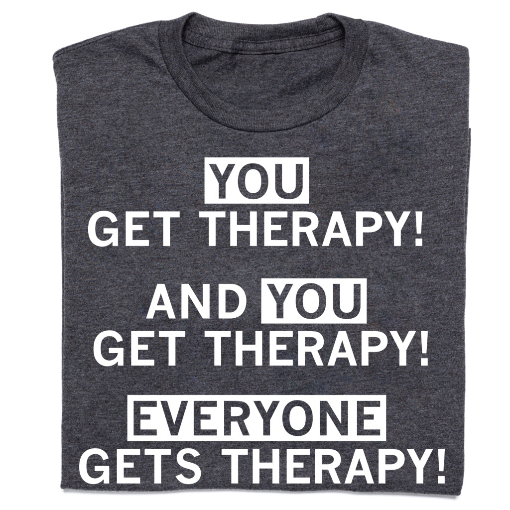 Dark gray Arcus Behavioral Health t-shirt with white text that reads, YOU GET THERAPY! AND YOU GET THERAPY! EVERYONE GETS THERAPY! with the words YOU and EVERYONE enclosed in white rectangles.