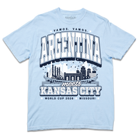 A hydrangea heavyweight t-shirt with navy and white ink. From the top to the bottom the text reads "Vamos, Vamos, Argentina meets Kansas City. World Cup 2026, Missouri." In the center is an illustration depicting notable buildings from Argentina and Kansas City mixed together.