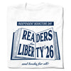 White t-shirt featuring an Independent Bookstore Day graphic of an open book with the text READERS for LIBERTY 26 and books for all!.