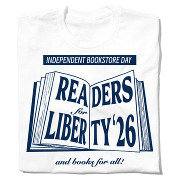 White t-shirt featuring an Independent Bookstore Day graphic of an open book with the text READERS for LIBERTY 26 and books for all!.