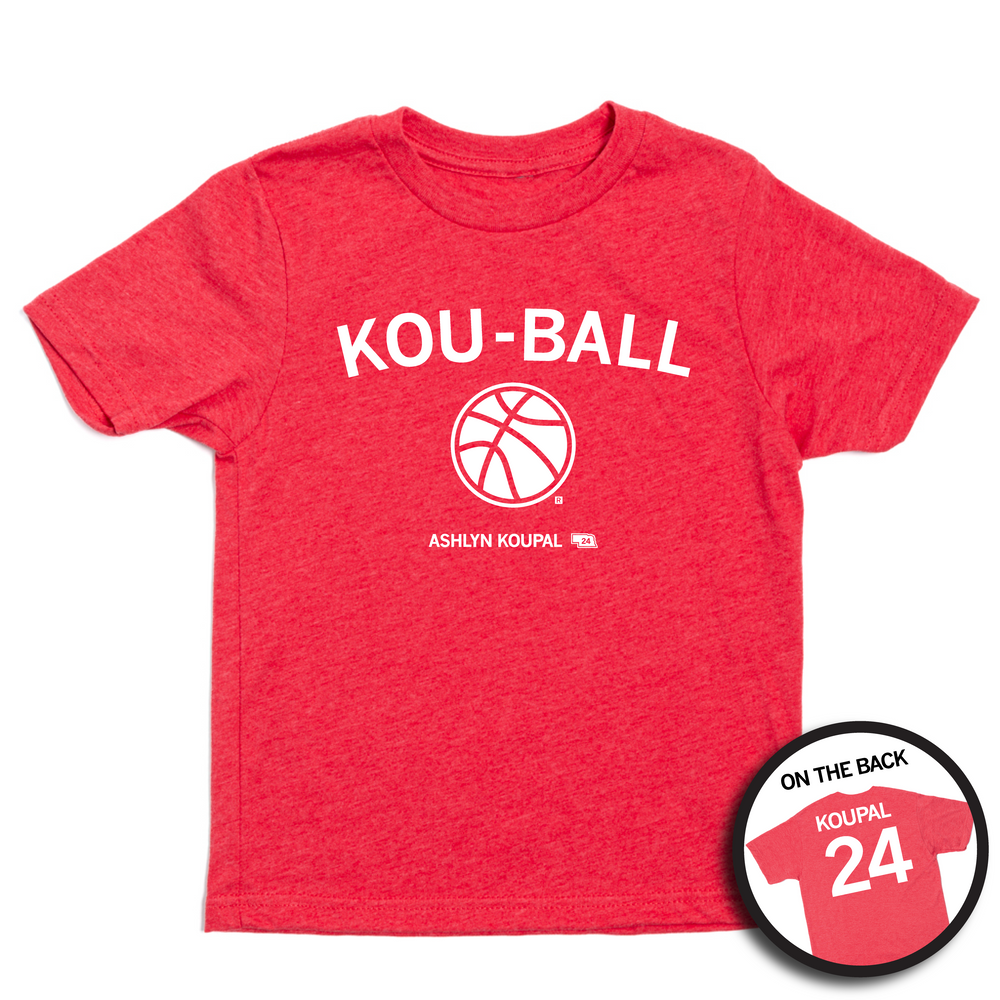 A youth-sized short sleeve heather red shirt with white ink that says, "KOU-BALL" above an illustration of a basketball. Smaller text below reads "ASHLYN KOUPAL" to the left of a small outline of Nebraska with the number 24 in it. The back print is laid out like a jersey with "KOUPAL" printed across the shoulders above the number 24.