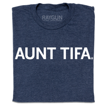A folded heather navy t-shirt with white ink text that says, " Aunt Tifa"