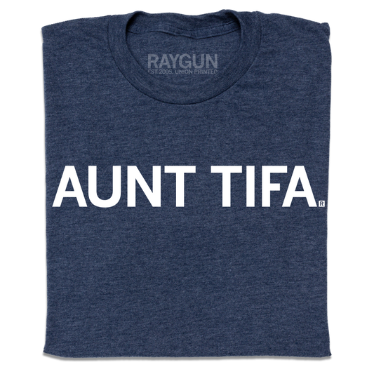 A folded heather navy t-shirt with white ink text that says, " Aunt Tifa"