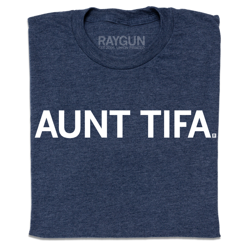 A folded heather navy t-shirt with white ink text that says, " Aunt Tifa"