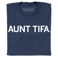 A folded heather navy t-shirt with white ink text that says, " Aunt Tifa"