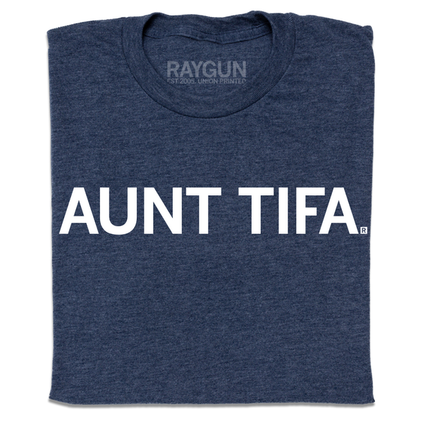 A folded heather navy t-shirt with white ink text that says, 
